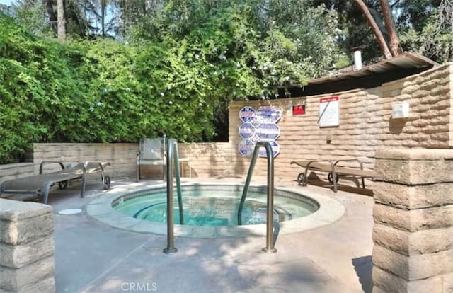 view of pool with a patio and a community hot tub