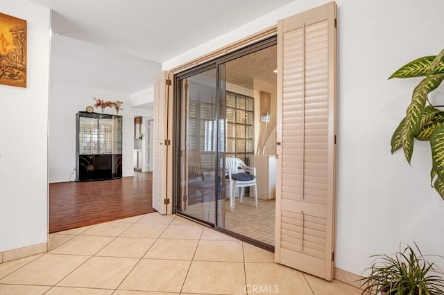 hall with light tile patterned floors