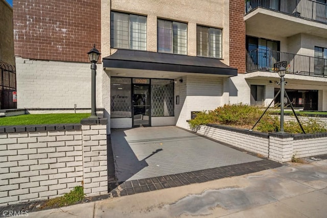 entrance to property featuring brick siding