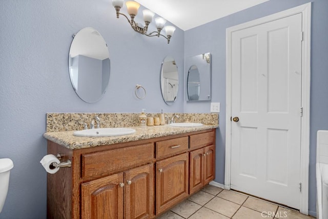 full bathroom featuring tile patterned flooring, double vanity, toilet, and a sink