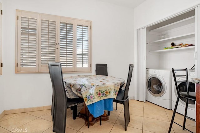 tiled dining area with baseboards and washer / clothes dryer