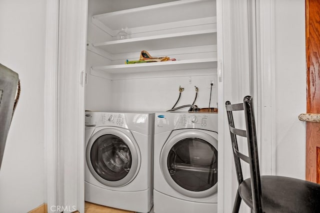 clothes washing area featuring independent washer and dryer and laundry area