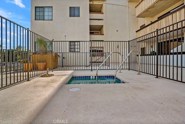 view of pool with a swimming pool, a patio area, and fence