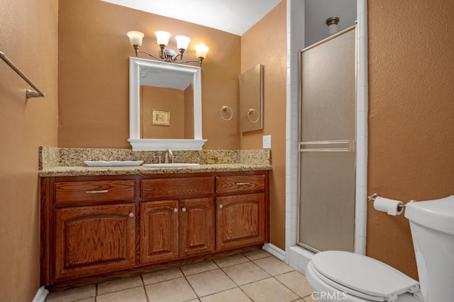 bathroom featuring tile patterned flooring, toilet, vanity, and a shower with door