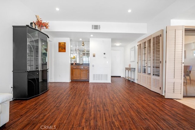 unfurnished living room featuring recessed lighting, visible vents, and wood finished floors