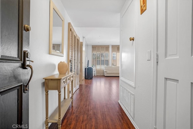 corridor with visible vents and dark wood-type flooring