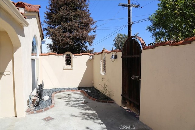 view of patio with a gate and fence