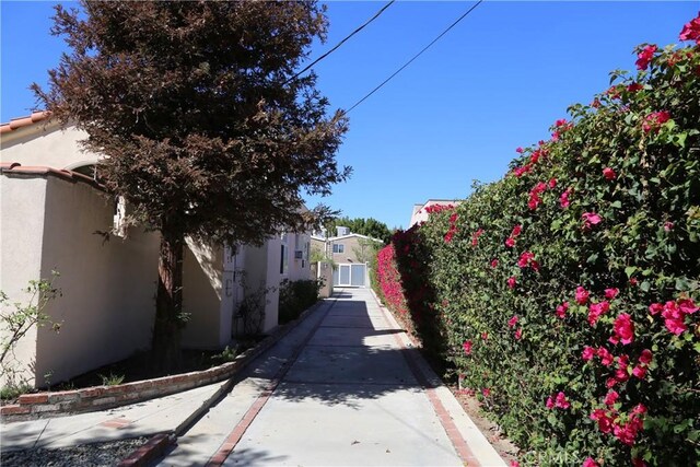 view of street featuring a gate and curbs