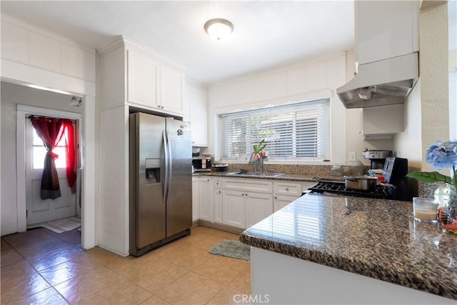 kitchen featuring stainless steel fridge with ice dispenser, a sink, extractor fan, white cabinetry, and range