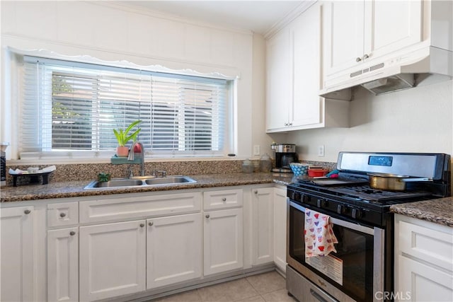 kitchen featuring under cabinet range hood, gas range, ornamental molding, white cabinets, and a sink