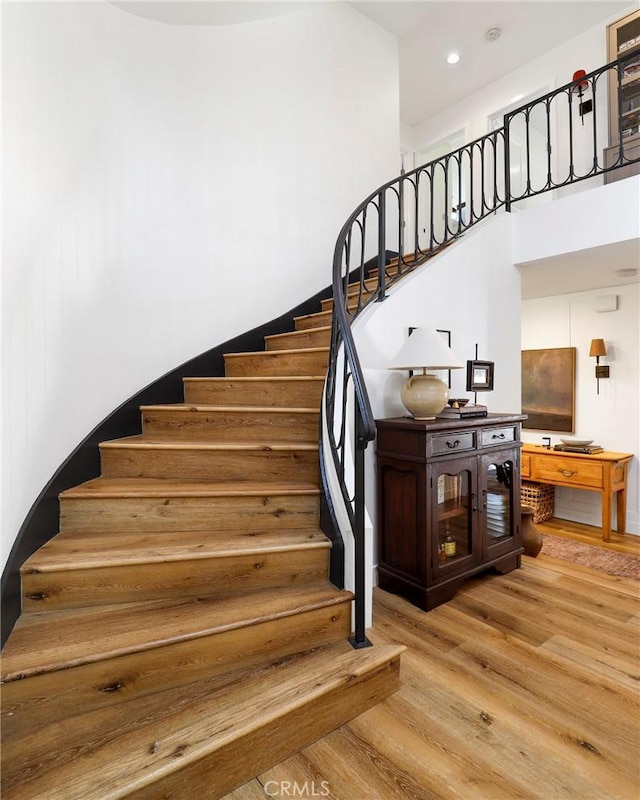 stairway featuring recessed lighting and wood finished floors