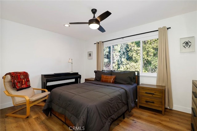 bedroom with light wood finished floors, recessed lighting, and baseboards