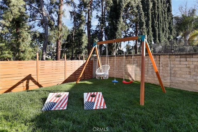 view of jungle gym with a yard and a fenced backyard