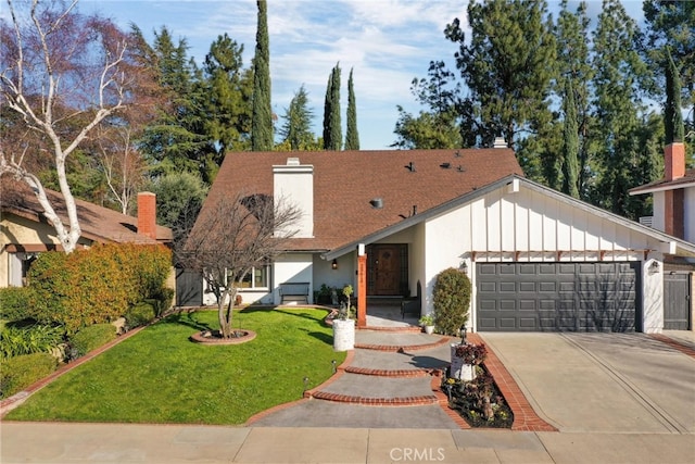 view of front facade with board and batten siding, concrete driveway, a front yard, a chimney, and a garage