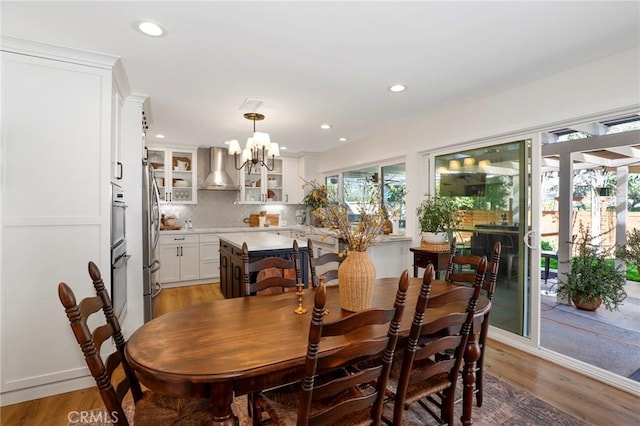 dining room featuring a notable chandelier, recessed lighting, and light wood-type flooring