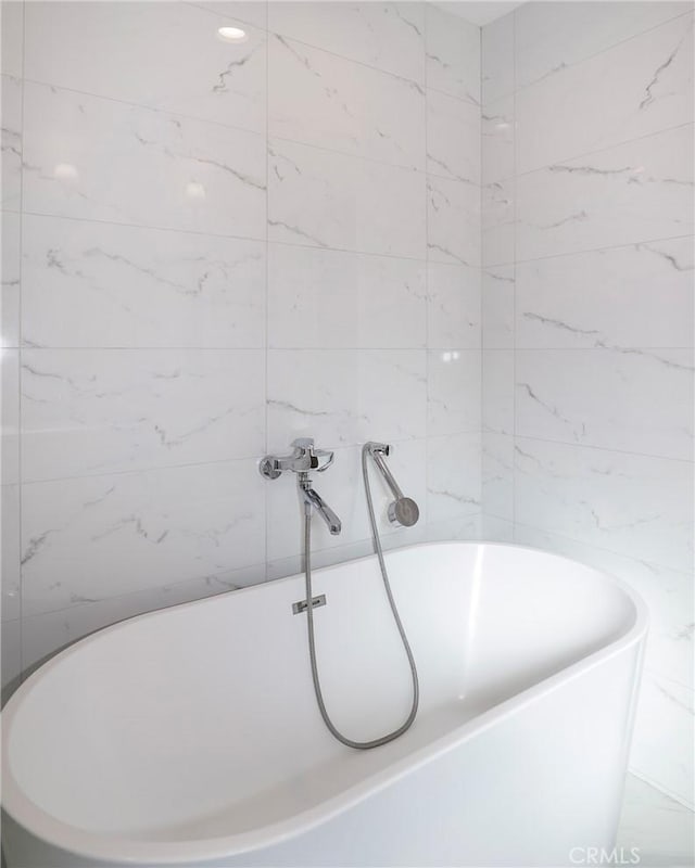 full bath with a freestanding bath