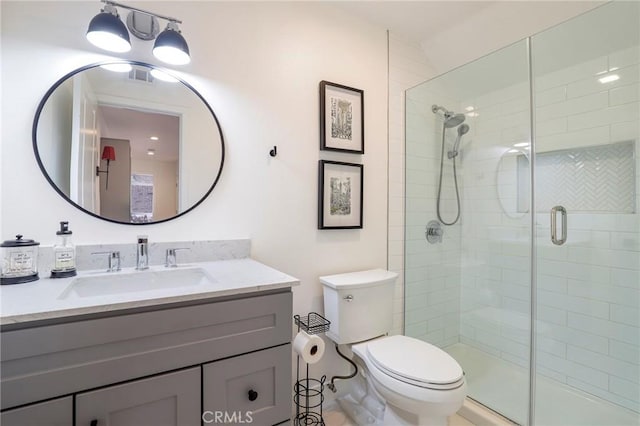 bathroom with visible vents, a shower stall, toilet, and vanity