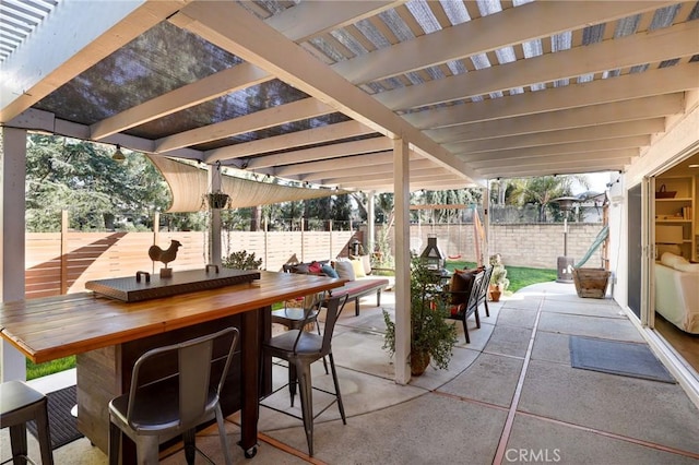 view of patio / terrace featuring fence and a pergola