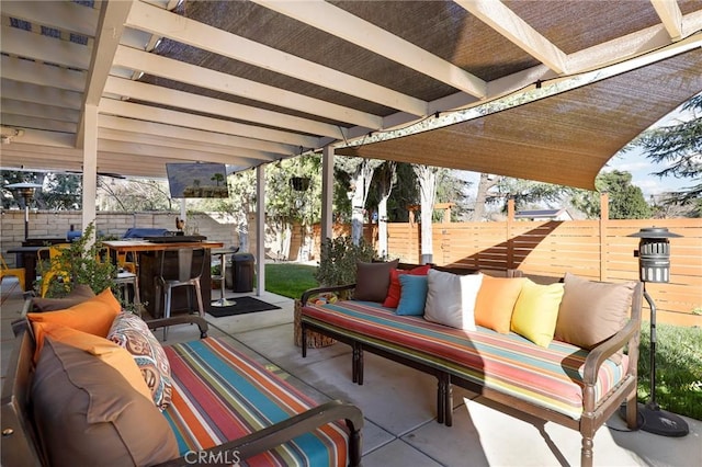 view of patio featuring outdoor dining space, an outdoor hangout area, and fence