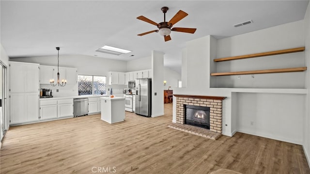 kitchen featuring visible vents, light countertops, appliances with stainless steel finishes, white cabinetry, and open floor plan