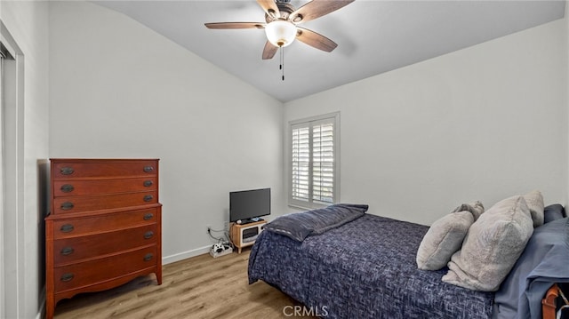 bedroom with vaulted ceiling, baseboards, light wood-type flooring, and ceiling fan