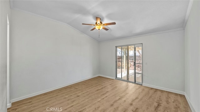 spare room featuring lofted ceiling, light wood-style flooring, and crown molding