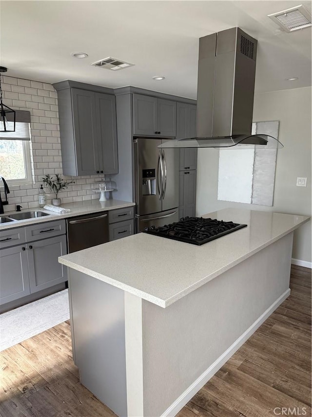 kitchen with dishwasher, range hood, gray cabinets, and stainless steel fridge