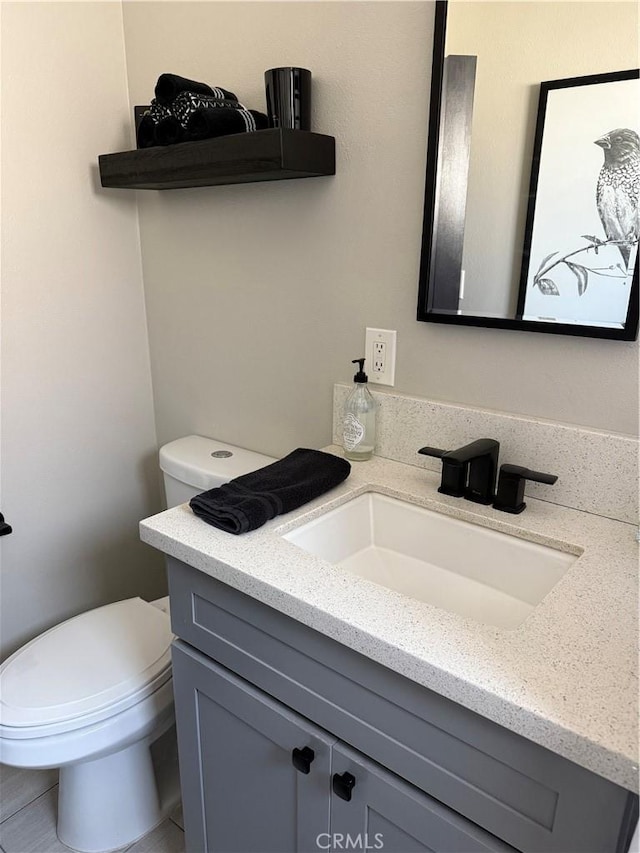 bathroom featuring toilet and vanity