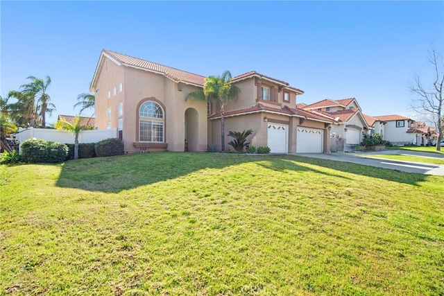 mediterranean / spanish house with a front lawn, fence, a tiled roof, stucco siding, and driveway