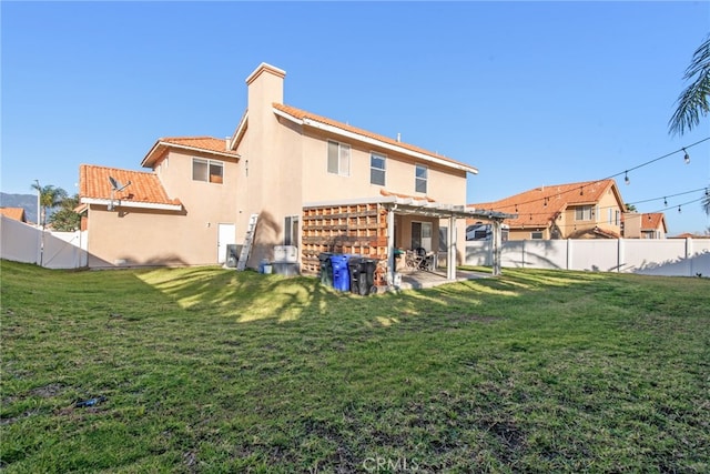 rear view of property featuring a gate, a yard, a fenced backyard, stucco siding, and a patio area