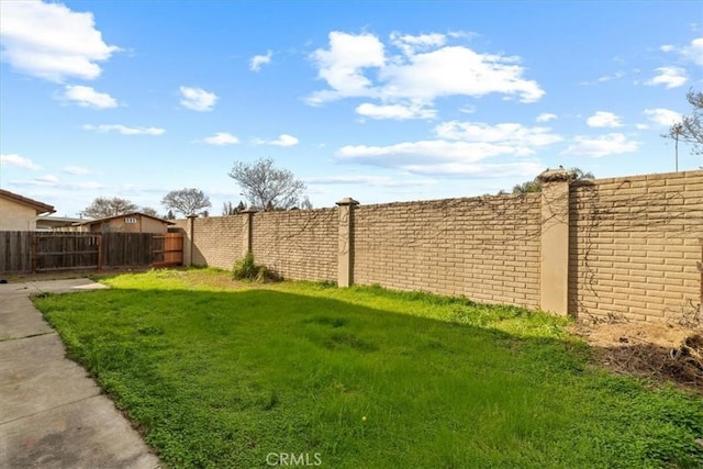 view of yard with a fenced backyard