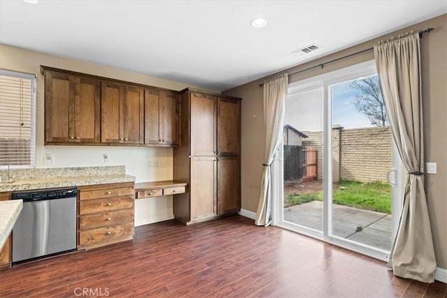 kitchen featuring visible vents, baseboards, light stone countertops, dishwasher, and dark wood-style flooring