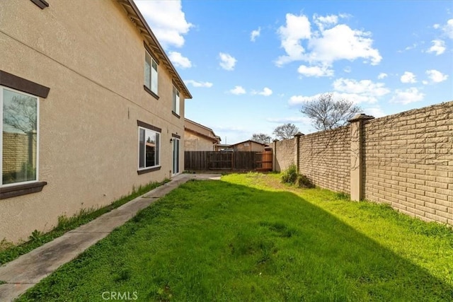 view of yard with a fenced backyard