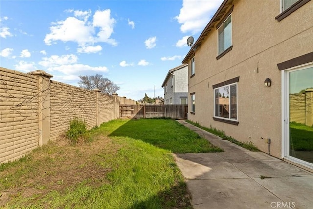 view of yard with a fenced backyard and a patio area