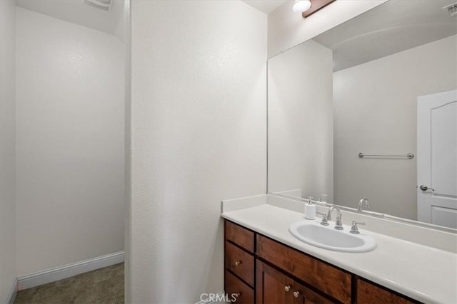 bathroom with visible vents, baseboards, and vanity