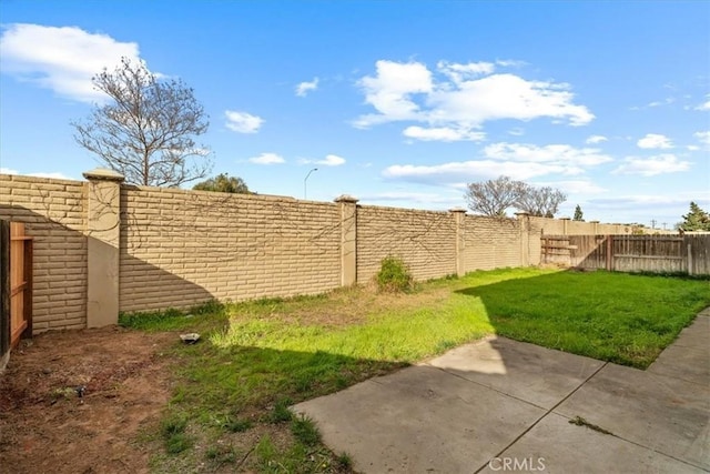 view of yard featuring a patio area and a fenced backyard