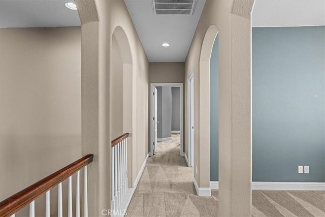 hall featuring recessed lighting, visible vents, baseboards, and carpet flooring