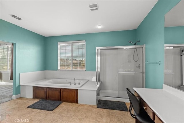 bathroom featuring a wealth of natural light, visible vents, a garden tub, and a stall shower