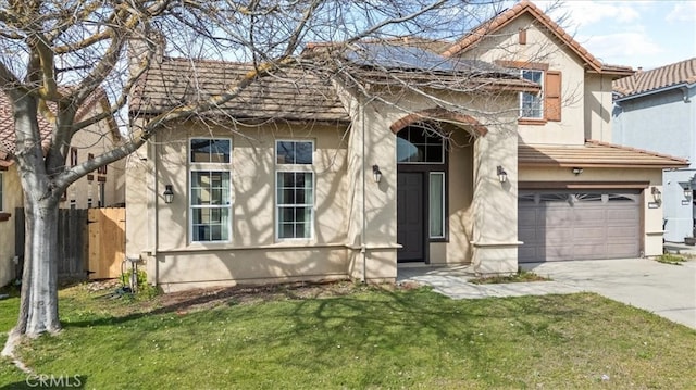 view of front of house featuring a front lawn, fence, driveway, and stucco siding