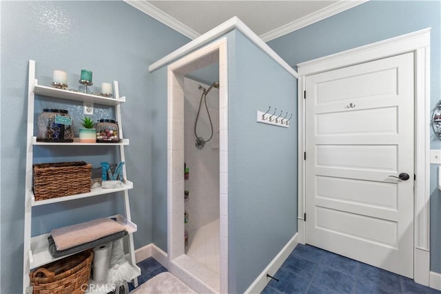 bathroom featuring tile patterned floors, tiled shower, baseboards, and ornamental molding