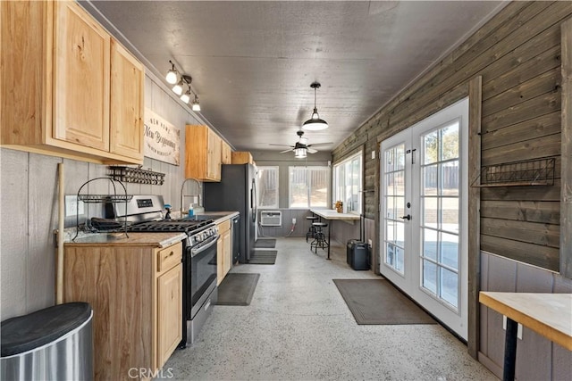 kitchen featuring light brown cabinets, an AC wall unit, light countertops, french doors, and gas stove