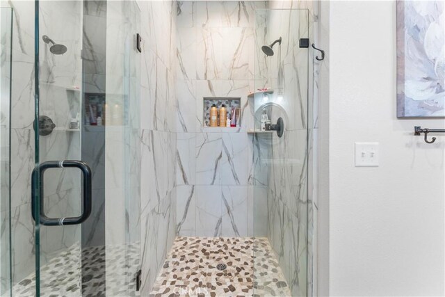 bathroom with a marble finish shower