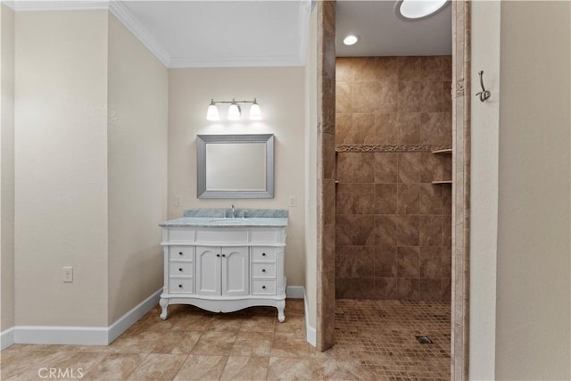 bathroom featuring vanity, a walk in shower, baseboards, and ornamental molding