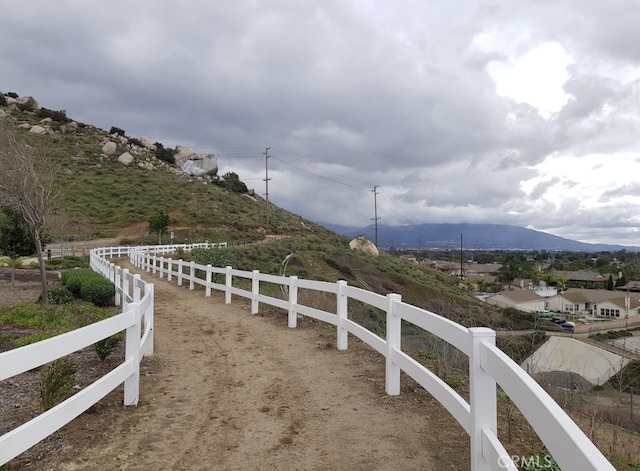 view of yard with a mountain view and fence