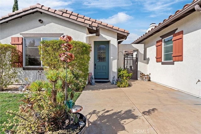 doorway to property with stucco siding and a patio