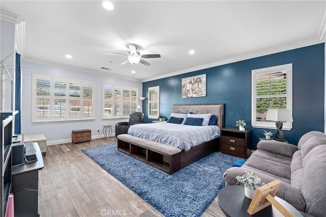 bedroom with recessed lighting, ornamental molding, baseboards, and wood finished floors