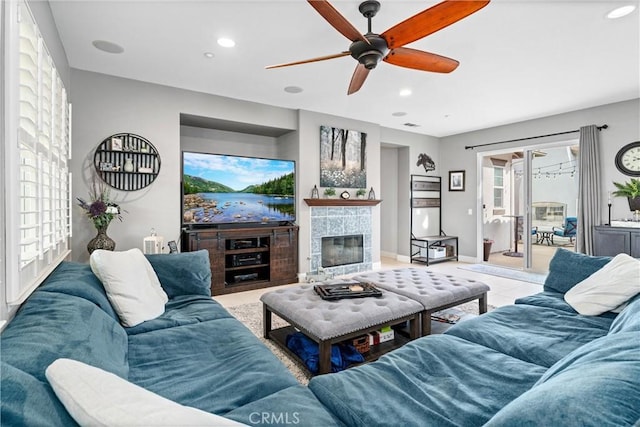 tiled living room with recessed lighting, a tile fireplace, baseboards, and ceiling fan