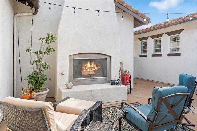 view of patio / terrace with a glass covered fireplace