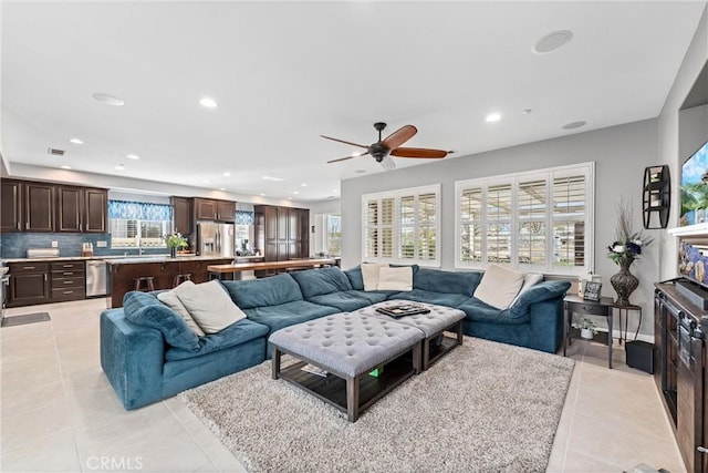 living room with light tile patterned flooring, recessed lighting, visible vents, and ceiling fan