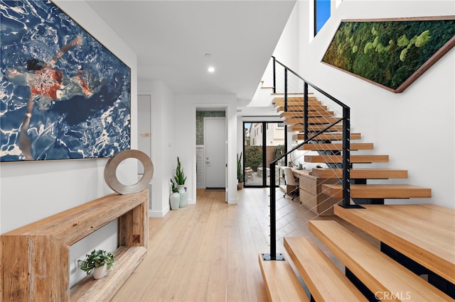 foyer entrance with recessed lighting, stairs, baseboards, and wood finished floors